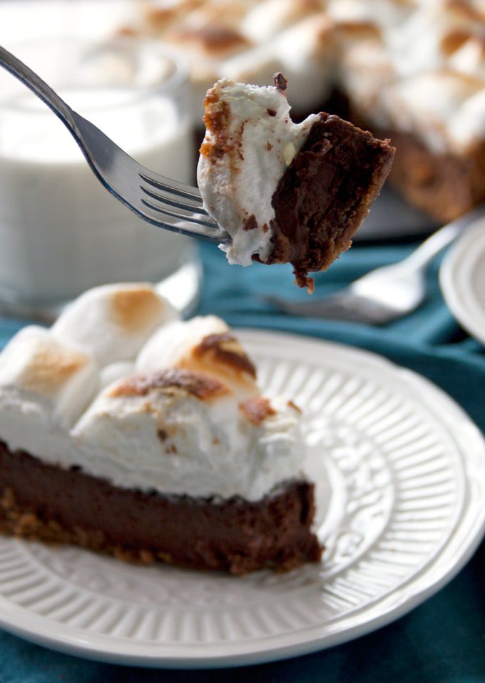 This decadent dessert starts with a graham cracker crust, is filled with a super chocolatey, ultra creamy middle and is finished with toasted marshmallows to make your favorite childhood treat into an elegant and delicious pie.