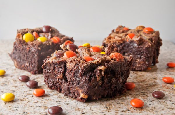 Fudgy, rich flourless triple chocolate brownies laced with peanut butter swirl, Reese's Pieces and chopped up Reese's cups. Just do it. 