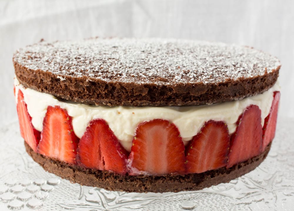 close up chocolate cake with strawberries and cream
