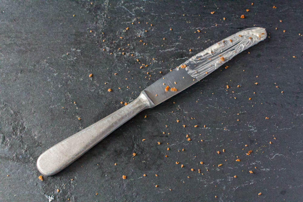 Buttered knife with crumbs