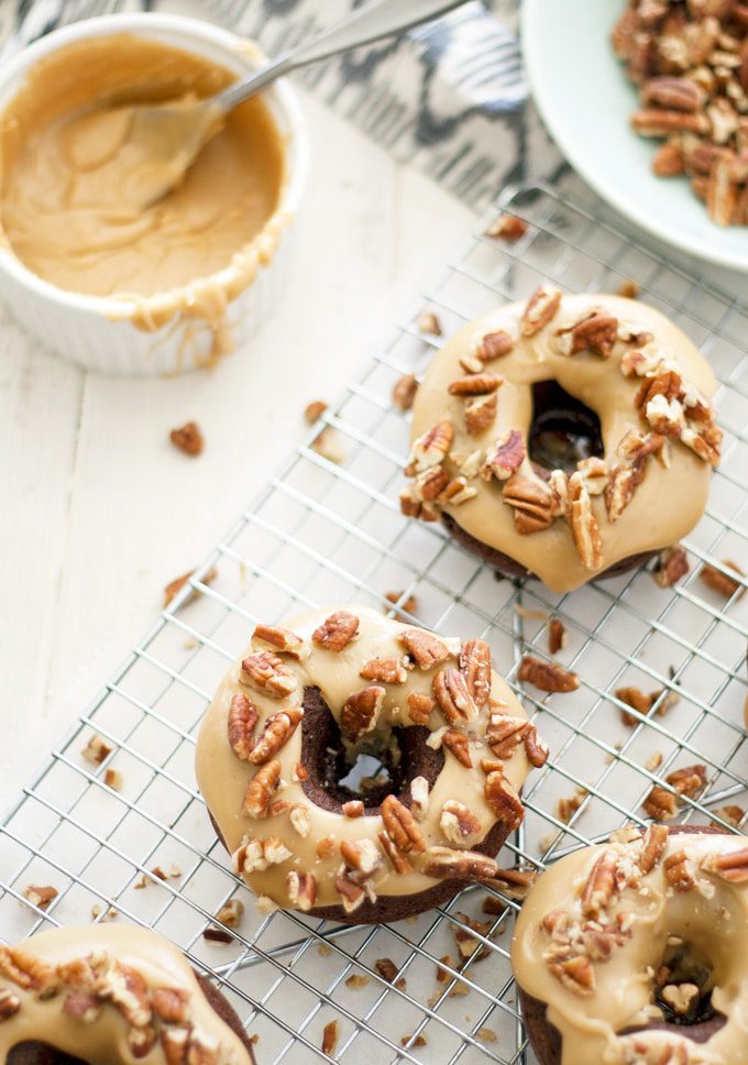 These turtle donuts start with a chocolate decadent donut, topped with caramel glaze and sprinkled with chopped pecans. | ahappyfooddance.com