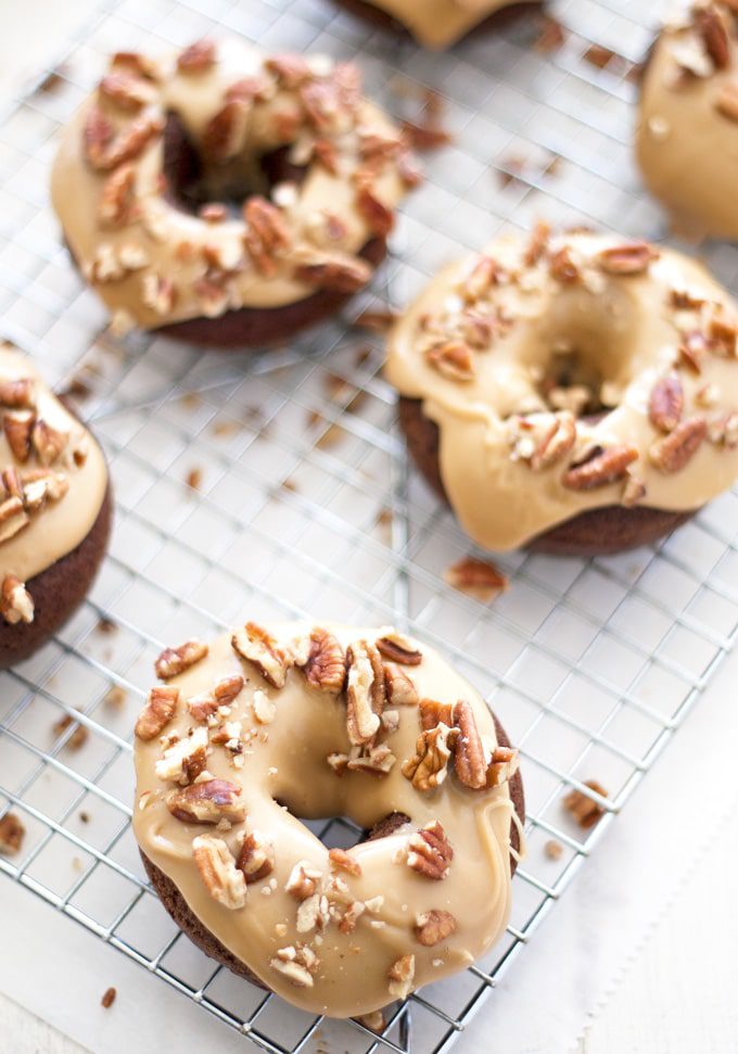 These turtle donuts start with a chocolate decadent donut, topped with caramel glaze and sprinkled with chopped pecans. | ahappyfooddance.com