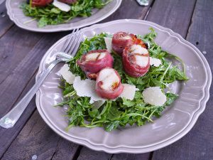 Grilled Prosciutto Wrapped Scallops Over Arugula, Pesto And Parmesan Salad